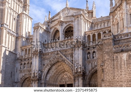 Toledo Cathedral (The Primatial Cathedral of Saint Mary of Toledo) richly decorated Gothic facade with Puerta del Perdon (Portal of Forgiveness), reliefs, carvings and spires.
