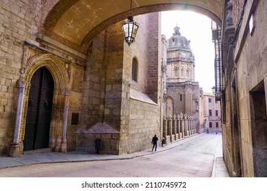 Toledo Cathedral under the stone arch of an old building in the city of Toledo Spain.