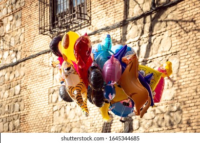 Toledo, Spain - 12.26.2019: A Pile Of Colored Balloons With Different Animals Forms, Inflated With Helium, In One Market During The Christmas Time In Toledo, Spain.