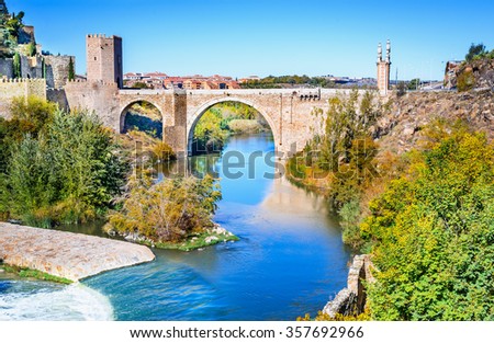 Toledo, Spain. Alcantara Bridge ( Puente de Alcantara ) is an arch bridge in Toledo, Spain, spanning the Tagus River.