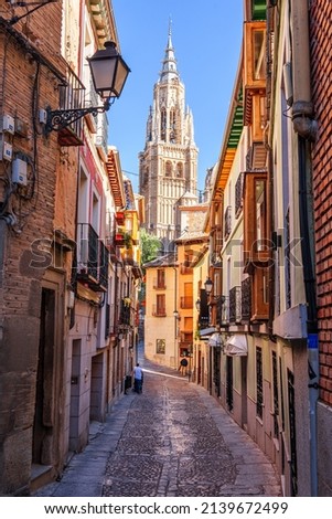 Toledo, Spain alleyway towards Toledo Cathedral in the afternoon.