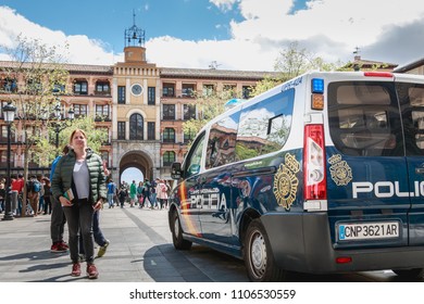 Toledo, Spain - April 28, 2018: On The Central Square Of The City On A Spring Day, A Spanish Police Car Monitors Tourists