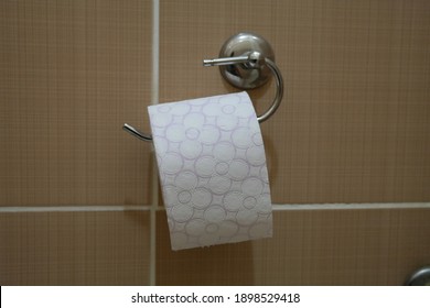 Toliet Paper Roll Placed On A Toliet Paper Holder Inside Of A Restroom Stall