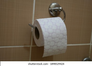 Toliet Paper Roll Placed On A Toliet Paper Holder Inside Of A Restroom Stall