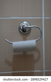 Toliet Paper Roll Placed On A Toliet Paper Holder Inside Of A Restroom Stall