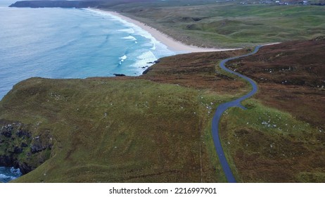 Tolsta, Isle Of Lewis, Outer Hebrides, Scotland, Britain, October 2022, Aerial View Of Minor Rural Road Winding Towards Sandy Beach In Distance