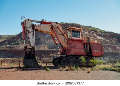 TOM PRICE, WESTERN AUSTRALIA - JULY 9, 2018: Old red excavator in Tom Price iron ore mine in Pilbara region at tourist tour