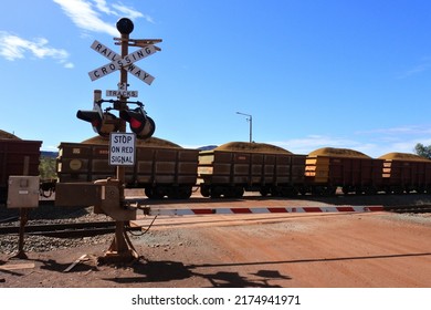 TOM PRICE,WA - JUNE 11 2022:Rio Tinto's iron ore train cars journey on the world's largest private rail network with over 1400km of tracks connecting mines at Tom Price with Dampier and Port Lambert