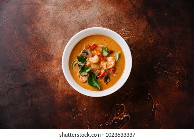 Tom Yam kung Spicy Thai soup with shrimp, seafood, coconut milk and chili pepper in bowl copy space