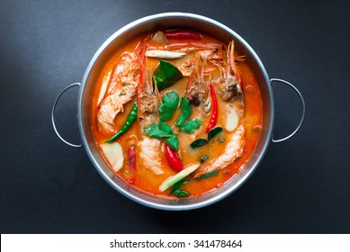 Tom Yum Goong,Thai Food In Hot Pot, Top View On Black Background