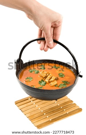 Tom Yum soup. Tom Yum kung Spicy Thai soup with chicken in a black bowl