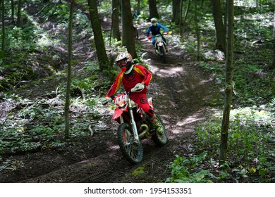 Tomah, Wisconsin USA - October 11th, 2020: Dirt Bike Riders Travel Through Forest Track In A GP Motocross Race Event.  