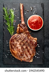 Tomahawk Beef Steak Grilled With Spices On Stone Background