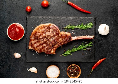 Tomahawk Beef Steak Grilled With Spices On Stone Background