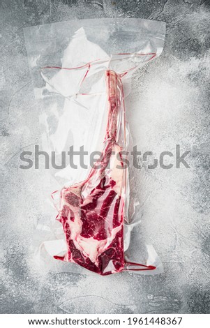 Similar – Dry aged raw tomahawk beef steak isolated on white background