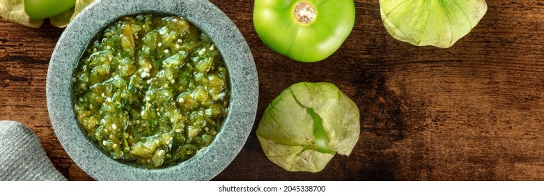 Tomatillos, Green Tomatoes, And Salsa Verde, Green Sauce, Panorama With A Molcajete, Traditional Mexican Mortar, Overhead Flat Lay Shot With Copy Space