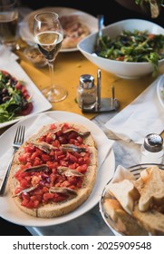 Tomato And Anchovy Bruschetta, Salad And Prosecco In Italian Tavern