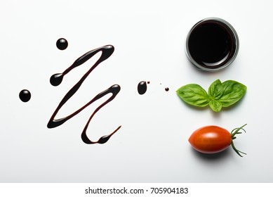 Tomato, Basil Leaf And Balsamic Vinegar On White Background