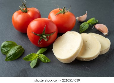 Tomato Basil Mozzarella Garlic On A Dark Background