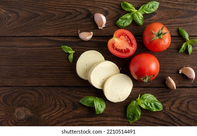 Tomato Basil Mozzarella Garlic On A Dark Background