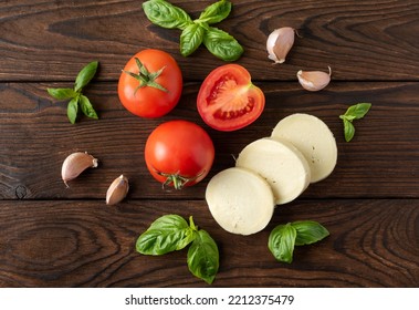 Tomato Basil Mozzarella Garlic On A Dark Background