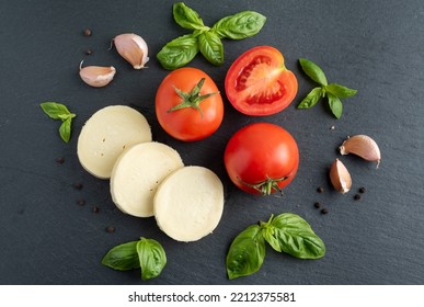 Tomato Basil Mozzarella Garlic On A Dark Background