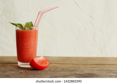 Tomato And Basil Smoothie. Tomato Fresh. A Glass, A Peace Of Tomato, Basil Leaves. Horizontal Orientation, Copy Space. Wooden Table, Light Background