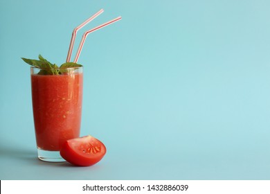 Tomato And Basil Smoothie. Tomato Fresh. A Glass, A Peace Of Tomato, Basil Leaves. Horizontal Orientation, Copy Space. Blue Background