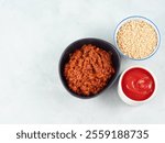 Tomato bolognese ragu with soya protein granules in bowl on gray background. Easy vegan soybean sauce for pasta