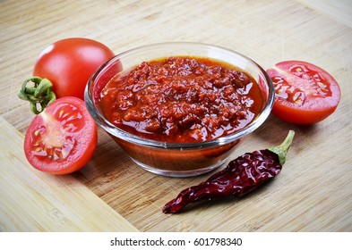 Tomato Chutney In A Glass Bowl On A Wooden Background