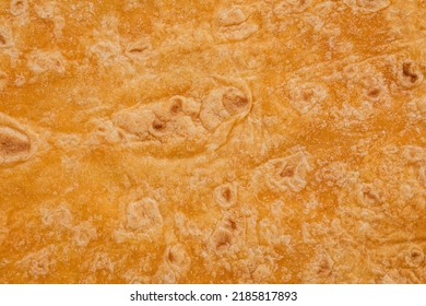 Tomato Flavored Wheat Tortilla Wraps. Spanish Or Mexican Circular Unleavened Flatbread From Wheat Flour. Ingredient For Cooking Fast Food Or Snack. Closeup, Texture Background