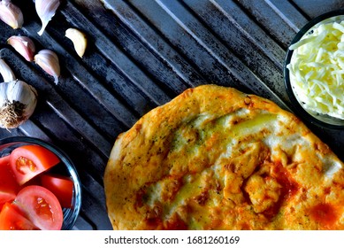 Tomato And Garlic Flatbread On A Rustic Tray