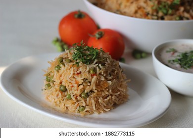 Tomato Green Peas Pulao Served With Curd Based Tomato And Onion Salad