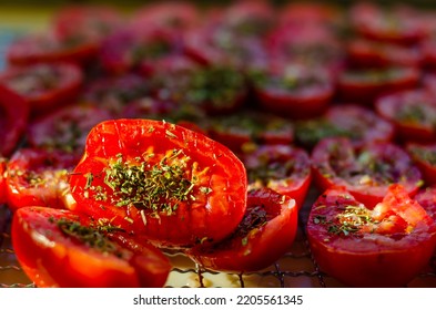 Tomato Halves Sprinkled With Herbs On Pallets For Drying.