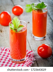 tomato juice and fresh tomato on wooden background