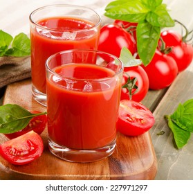 Tomato juice and fresh tomatoes  on  a wooden table. Selective focus