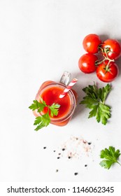 Tomato juice with fresh tomatoes, parsley, sea salt and pepper on light grey background. Vegetable drink. - Shutterstock ID 1146062345