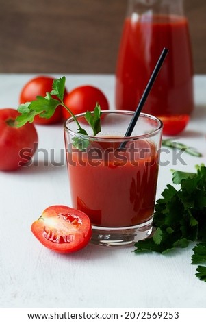 tomato juice and fresh tomatoes. fresh Tomato juice with salt and parsley. Bloody Mary cocktail with ingredients. Alcoholic drink with vodka and tomato juice in a glass isolated on a white background.