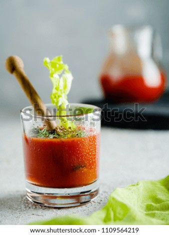 Tomato juice in glass with celery