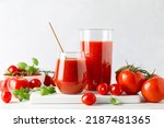 Tomato juice in a glass and fresh tomatoes