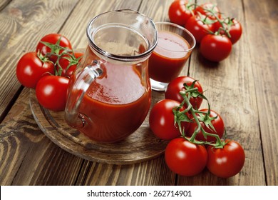 Tomato juice in a glass jar on a wooden table