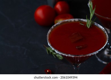 tomato juice in glass.close-up Bloody Mary cocktail. Alcoholic drink with vodka and tomato juice in a glass isolated on a black background. vampiro cocktail with pepper on table. copy space.