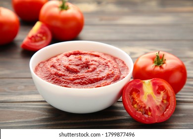 Tomato Ketchup Sauce In A Bowl With Tomatoes.