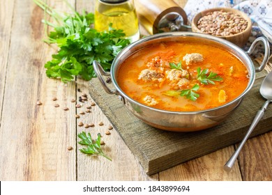 Tomato Lentil Soup With Meatballs And Vegetables On A Wooden Table. Copy Space.