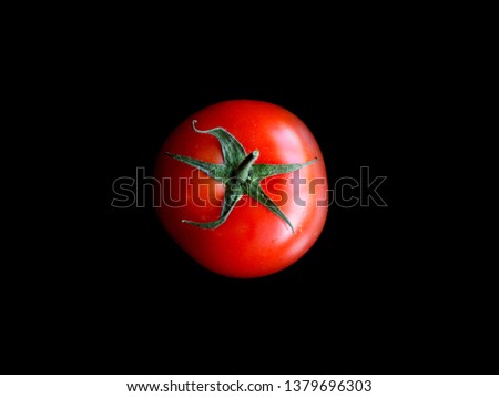 Tomato on black background. Healthy food concept. Close up macro