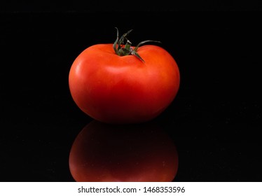 Tomato On A Black Shinny Floor