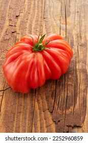 Tomato on a wooden background - Shutterstock ID 2252960859