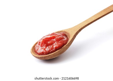 Tomato paste on a wooden spoon isolated on white background - Shutterstock ID 2121606698