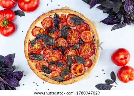 Tomato pie with red baisils, ricotta cheese, eggplants, orange zest. White background. Top view. Flat lay.