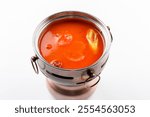 Tomato pot bottom with a small Hot pot on a white background